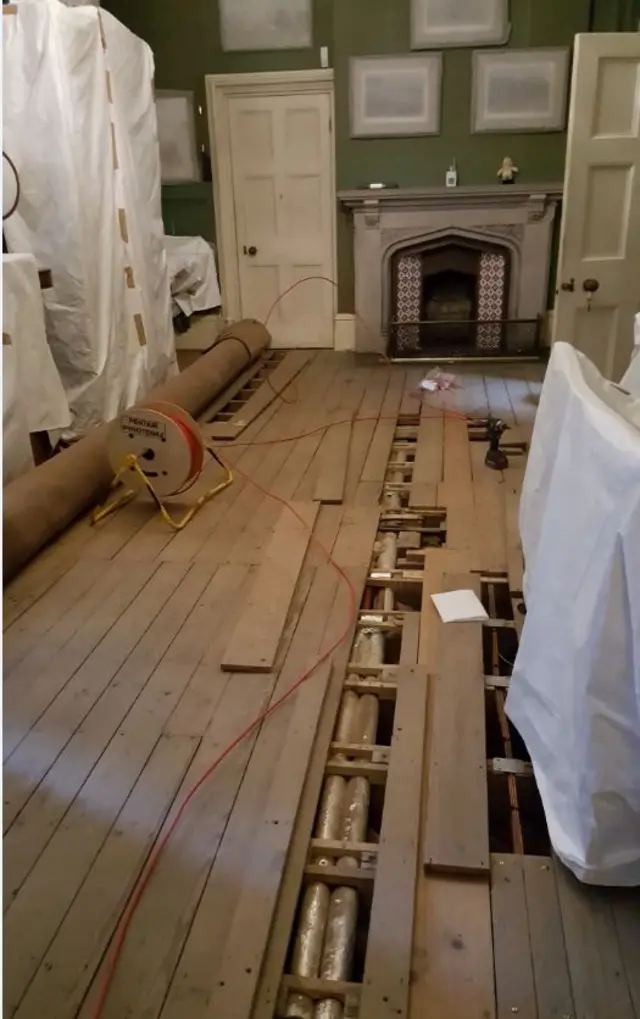 Floorboards removed from a room for the new fire alarm system to be fitted