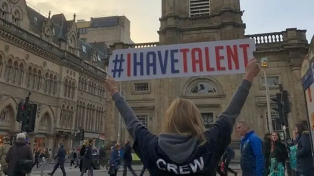 A woman with a sign