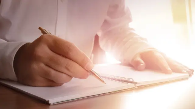 A man writing notes