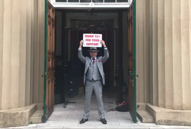 Deputy Carl Meerveld, of the winning Guernsey referendum option, holding up sign thanking voters.