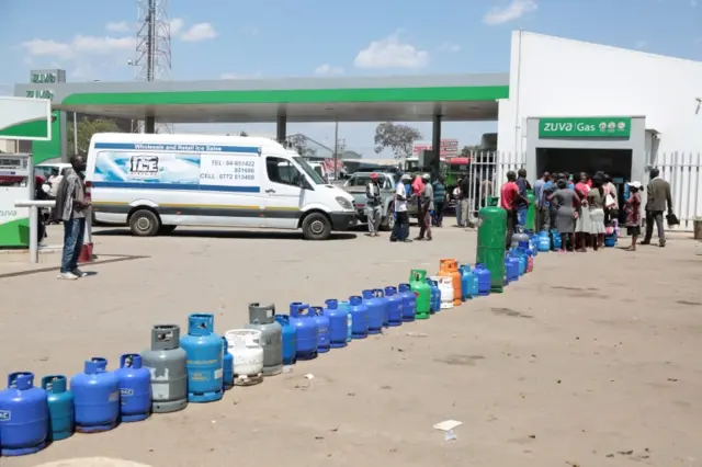 Queue of fuel bottles