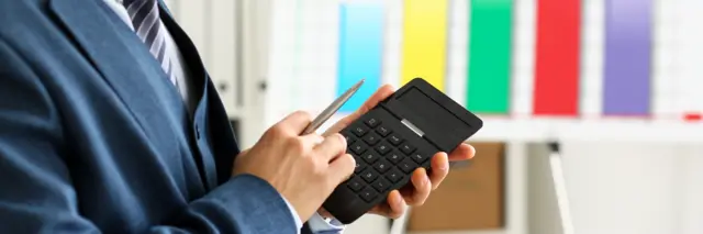 A man using a calculator