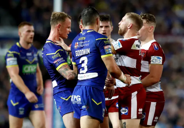 Warrington players clash with Wigan