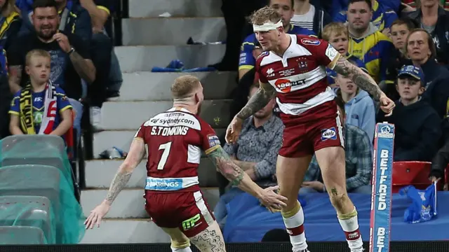 Wigan celebrate their third try