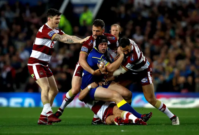 Warrington Wolves' Chris Hill (front) is tackled