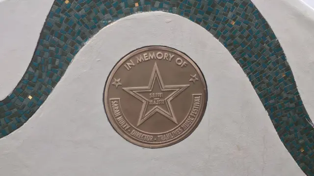 The round plaque on the wall