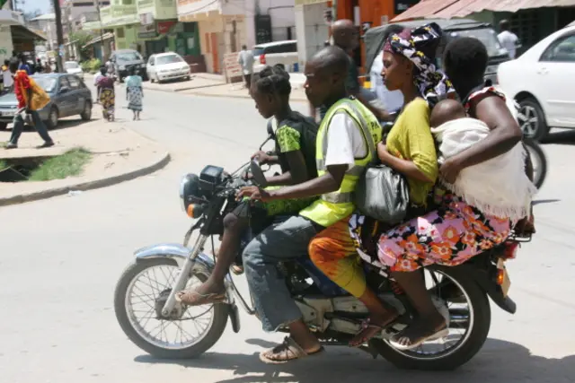 A boda boda operator transports passengers on April 22, 2012 in Malindi, Kenya.