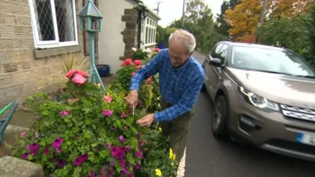 A man tending to the flowers