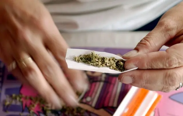 Woman rolling joint