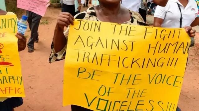 Women carry placards as rights activists, under the umbrella of the Justice Development and Peace commission, march against the illegal human trafficking and countrywide violence during a protest march on March 18, 2017 in Lagos.