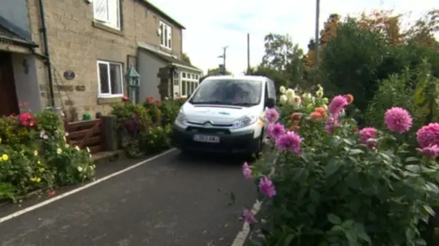 A van near the flowerbed