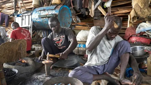 blacksmiths in Mali's river port of Mopti preparing parts used to build fishing boats