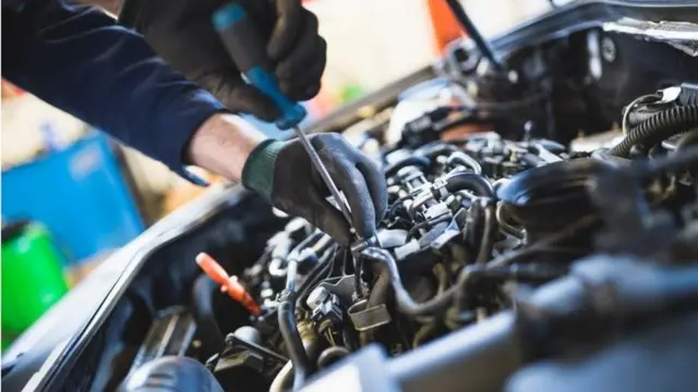 A mechanic working on a car