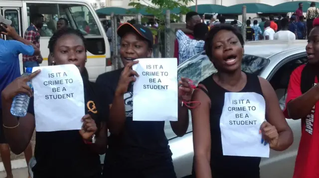 Students holding up signs