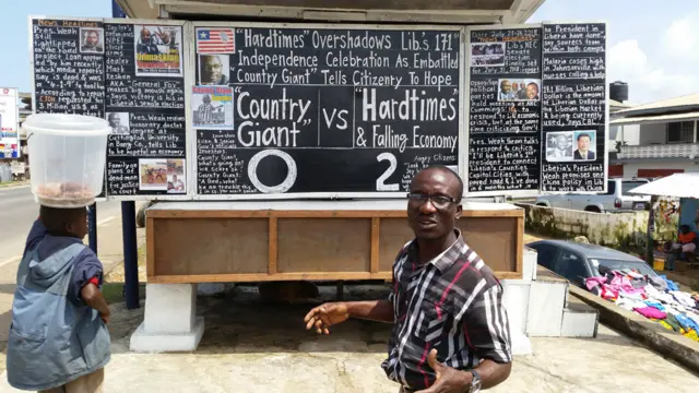 Man in front of his chalkboard