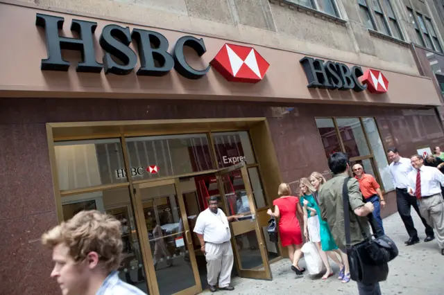 People walk past an HSBC Bank branch at 550 Fashion Avenue on August 1, 2011 in New York City.