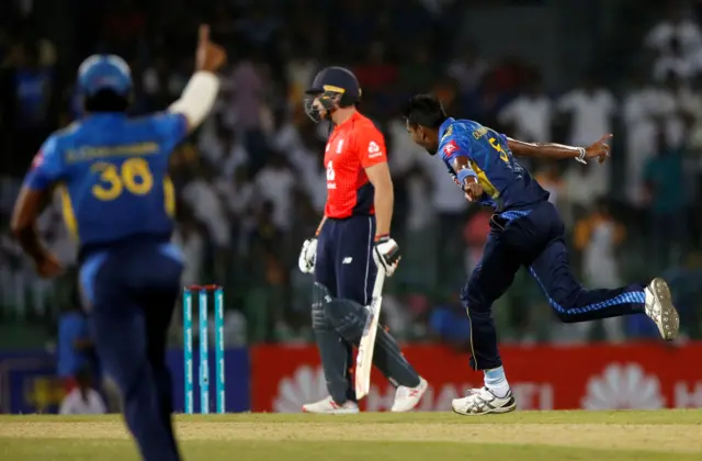 Sri Lanka"s Dushmantha Chameera (R) celebrates after taking the wicket of England"s captain Jos Buttler