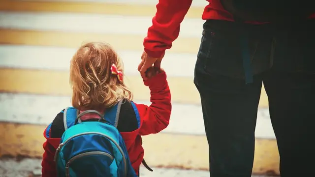 Child walking to school with parent