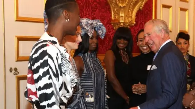 Prince Charles and models wearing designs from Lagos Fashion Week