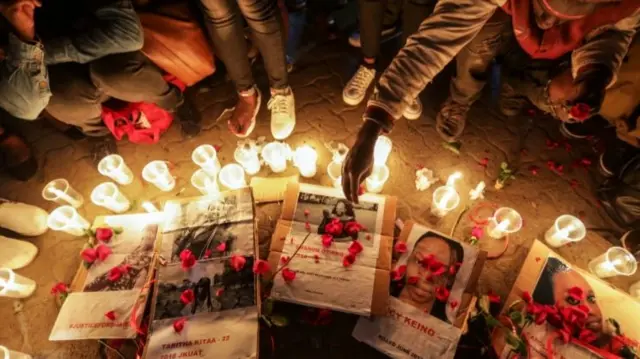 Kenyan activists light candles during a night vigil for the murdered university student Sharon Otieno - September 2018