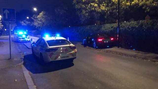 The crashed car next to police car