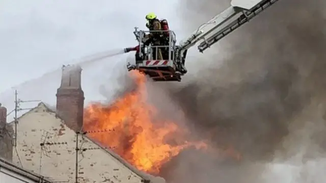 Firefighters tackle fire from aerial platform