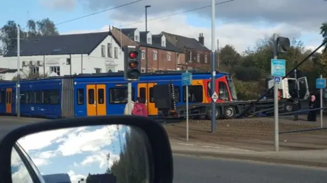 A lorry that's hit a tram