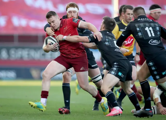 Munster's Rory Scannell is tackled by George Horne and Rob Harley of Glasgow Warriors