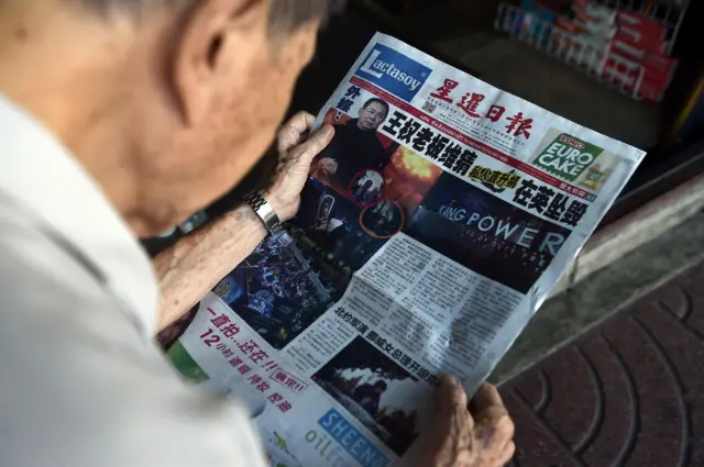 Man reading newspaper in Bangkok