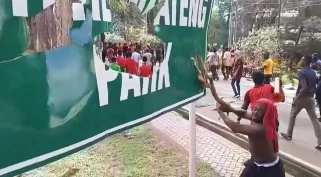 Man breaking a sign