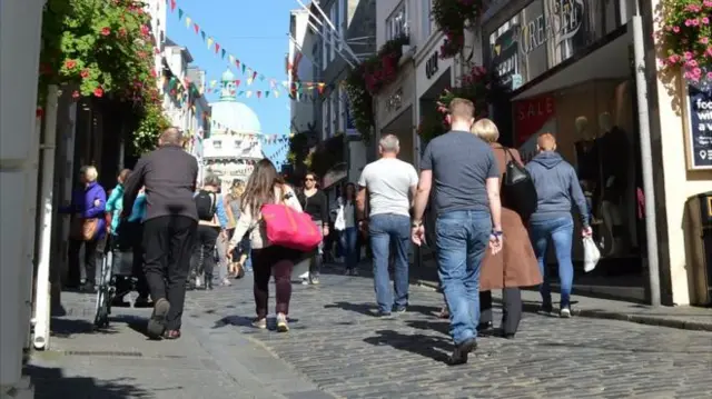 People walking along Guernsey's High Street