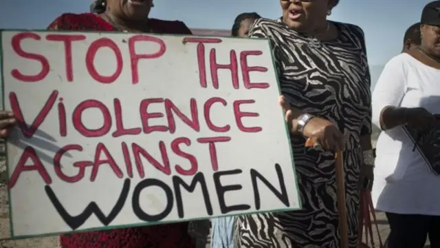 Women holding a sign