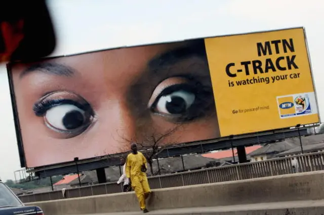 A man walks past a billboard for MTN, Africa's leading cullular telecommunication company on July 14, 2008 in Lagos, Nigeria.