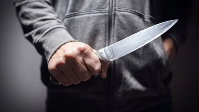 Person holding knife