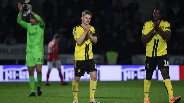 Burton Albion players applauding fans after game