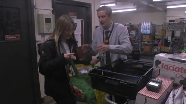 Cara Bilson picking up food from a supermarket