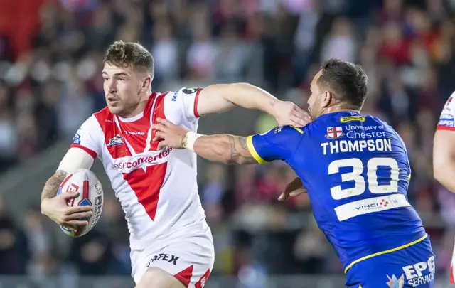 St Helens' Mark Percival fends off Warrington's Bodene Thompson