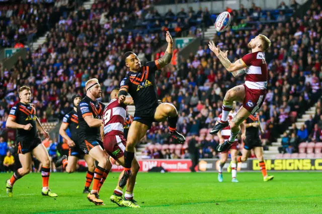 Sam Tomkins and Ben Roberts compete for a high ball