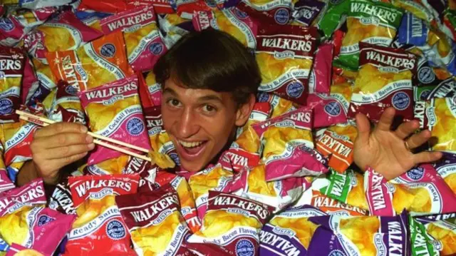 Gary Lineker surrounded by crisp packets