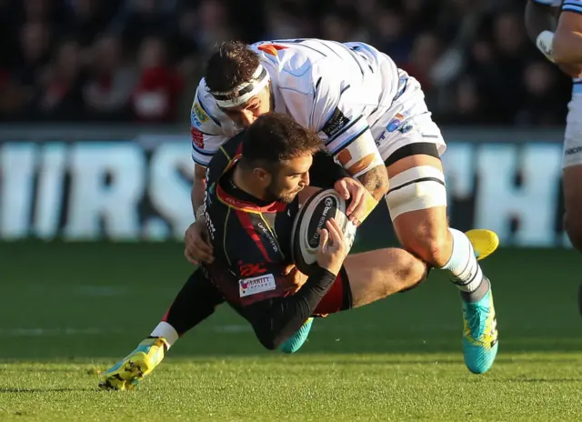 Jordan Williams of Dragons is tackled by Josh Turnbull of Cardiff Blues