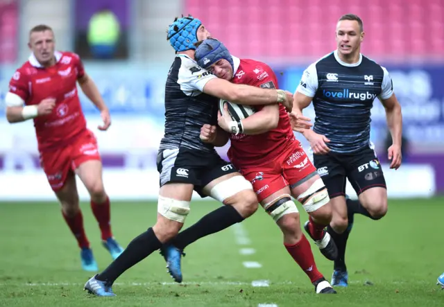 Will Boyde of Scarlets is tackled by Justin Tipuric of Ospreys