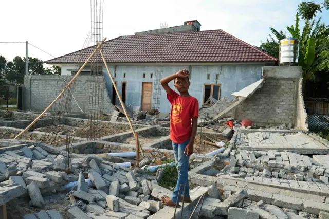 Boy among tsunami wreckage on the island of Sulawesi