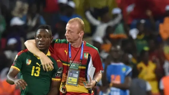 Cameroon's midfielder Christian Bassogog (L) celebrates with Cameroon's Belgian assistant coach Sven Vandenbroeck at the end of the 2017 Africa Cup of Nations semi-final football match between Cameroon and Ghana in Franceville on February 2, 2017.