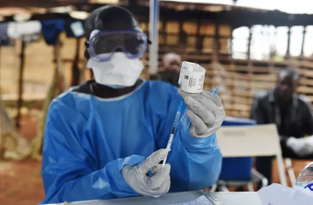 Worker preparing a vaccine