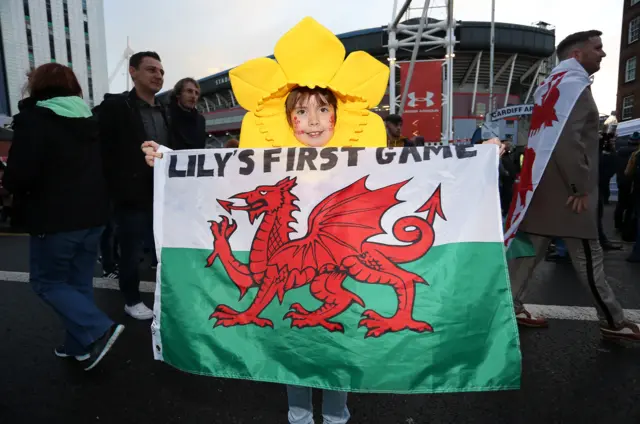 Little girl holding up her first game flag