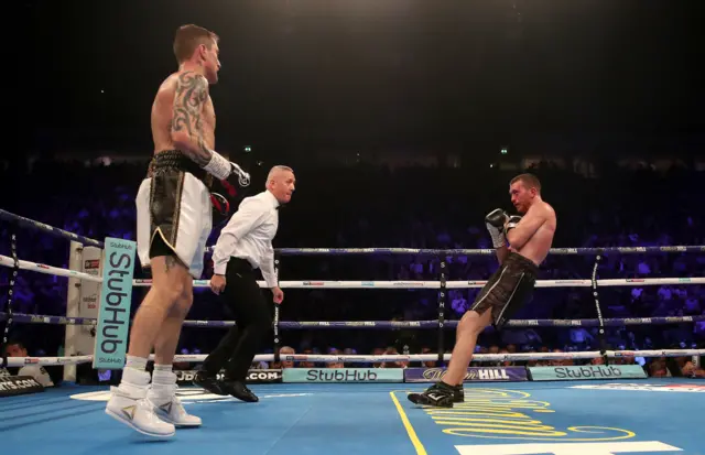 Scott Cardle falls to the floor as he is knocked down by Ricky Burns