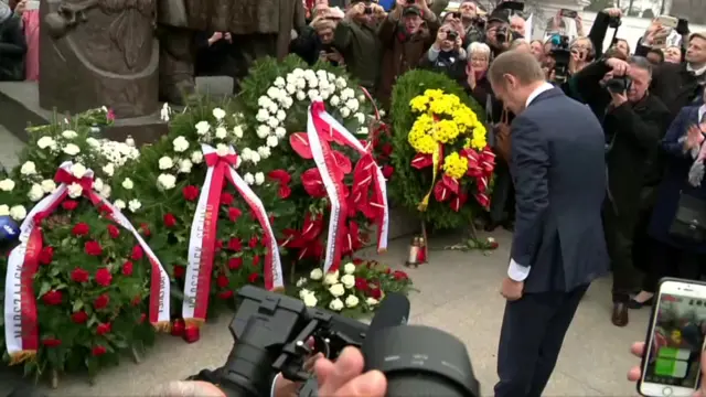 Donald Tusk lays a wreath in Poland