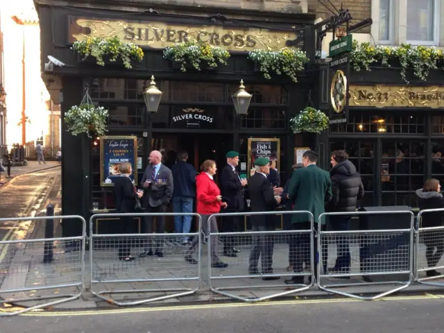 Some veterans gather outside a pub for a drink