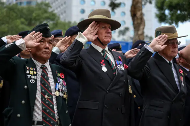 Veterans salute during a Remembrance Day ceremony at the Cenotaph in Hong Kong on 11 November 2018