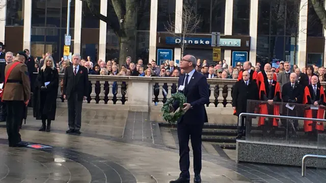 Irish foreign minister Simon Coveney laying a wreath in Belfast